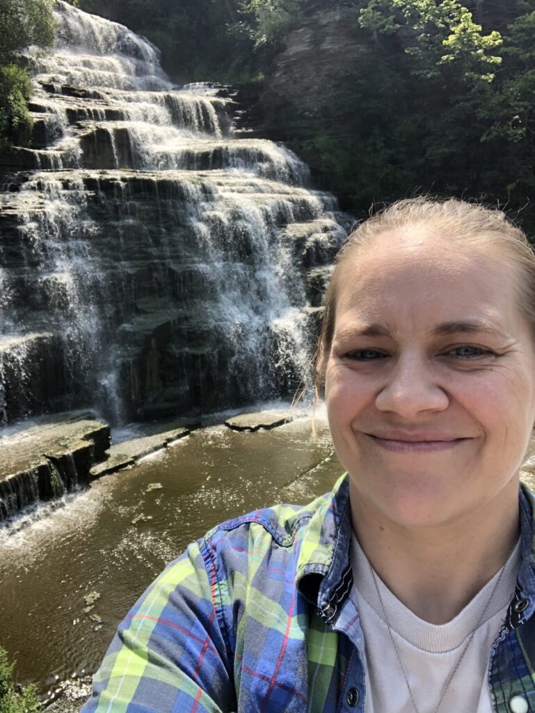 Picture of Director Amanda Zell in front of Hector Falls
